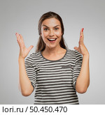 Portrait of a woman after receiving great news, over a gray background. Стоковое фото, агентство Ingram Publishing / Фотобанк Лори