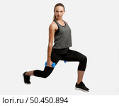 Young fitness woman making exercises with dumbbells. Стоковое фото, агентство Ingram Publishing / Фотобанк Лори