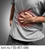 Stomachache Pain or painful stomach ache as an abdominal illness as Crohn’s disease or IBS and Ulcers representing intestinal inflammation or bloating. Стоковое фото, агентство Ingram Publishing / Фотобанк Лори