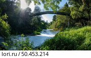 View from under the bridge of white foam pollutants swirling across the water surface floating on river Caima, Palmaz - Oliveira de Azemeis - Portugal. Стоковое фото, агентство Ingram Publishing / Фотобанк Лори