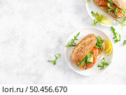 Sandwiches with salted salmon, arugula and cucumber. Breakfast. Top view. Стоковое фото, агентство Ingram Publishing / Фотобанк Лори