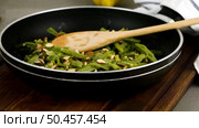 Green beans with roasted almonds on fry pan on kitchen countertop. Rotating slide. Стоковое фото, агентство Ingram Publishing / Фотобанк Лори