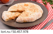 Italian food, pizza calzone with tomato, spinach and cheese on wooden background. Стоковое фото, агентство Ingram Publishing / Фотобанк Лори