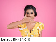 Young woman covering her mouth showing shut up. Стоковое фото, агентство Ingram Publishing / Фотобанк Лори