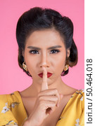 Beauty asian woman red lips and finger showing hush silence sign. Стоковое фото, агентство Ingram Publishing / Фотобанк Лори
