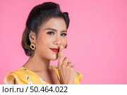 Beauty asian woman red lips and finger showing hush silence sign. Стоковое фото, агентство Ingram Publishing / Фотобанк Лори