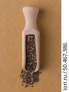 Top view of wooden scoop with chia seeds against yellow vinyl background. Стоковое фото, агентство Ingram Publishing / Фотобанк Лори