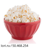 Popcorn in a red bowl on a white background. Стоковое фото, агентство Ingram Publishing / Фотобанк Лори
