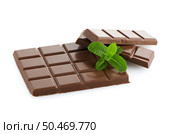 Closeup detail of chocolate parts and mint leaves on white background. Стоковое фото, агентство Ingram Publishing / Фотобанк Лори