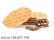 Pile of sweet waffles and chocolate parts on white background. Стоковое фото, агентство Ingram Publishing / Фотобанк Лори