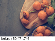 loquats on kitchen counter background. Vintage style. Стоковое фото, агентство Ingram Publishing / Фотобанк Лори