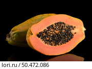 Fresh and tasty papaya on black background. Стоковое фото, агентство Ingram Publishing / Фотобанк Лори
