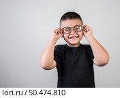 Funny boy genius wearing glasses in studio shot. Стоковое фото, агентство Ingram Publishing / Фотобанк Лори