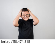 Boy feels sad after the parents scold him. Стоковое фото, агентство Ingram Publishing / Фотобанк Лори
