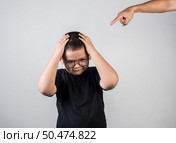 Boy feels sad after the parents scold him. Стоковое фото, агентство Ingram Publishing / Фотобанк Лори