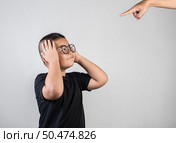 Boy feels sad after the parents scold him. Стоковое фото, агентство Ingram Publishing / Фотобанк Лори