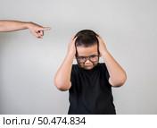 Boy feels sad after the parents scold him. Стоковое фото, агентство Ingram Publishing / Фотобанк Лори