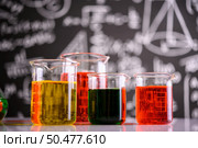 Laboratory glassware with liquids of different color. Стоковое фото, агентство Ingram Publishing / Фотобанк Лори