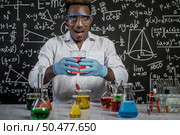 Scientists startled at the red chemical in the glass at the laboratory. Стоковое фото, агентство Ingram Publishing / Фотобанк Лори