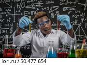 Scientists startled at the orange chemical in the glass at the laboratory. Стоковое фото, агентство Ingram Publishing / Фотобанк Лори