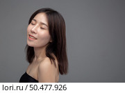 Women wearing black strapless tops and closing their eyes. Стоковое фото, агентство Ingram Publishing / Фотобанк Лори