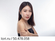 Women wearing black strapless blouses Turn your head to the right and grasp her arm. Стоковое фото, агентство Ingram Publishing / Фотобанк Лори