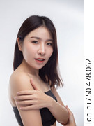 Women wearing black strapless blouses Turn your head to the right and grasp her arm. Стоковое фото, агентство Ingram Publishing / Фотобанк Лори
