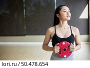 Women exercise with Dumbbell weight plates in the chest. Стоковое фото, агентство Ingram Publishing / Фотобанк Лори