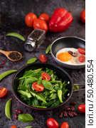Stir-Fried Kale in Oyster Sauce on a Pan with Peanuts, Peppers, Tomatoes and Red Beans on a Cement Floor. Стоковое фото, агентство Ingram Publishing / Фотобанк Лори