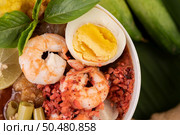 Tom Yum noodle with shrimp and boiled egg, accompanied by lime, cucumber, basil, eggplant and garlic. Стоковое фото, агентство Ingram Publishing / Фотобанк Лори