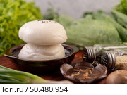 Steamed buns in a wooden dish on a wooden grill. Selective focus. Стоковое фото, агентство Ingram Publishing / Фотобанк Лори
