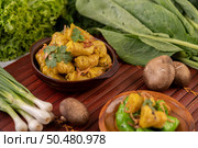 Shumai or Kanom Jeeb or Steamed Pork Dumplings on a plate, sprinkled with coriander and fried onions. Стоковое фото, агентство Ingram Publishing / Фотобанк Лори
