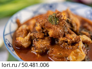 Sweet pork in a ceramic cup placed on a banana leaf. Стоковое фото, агентство Ingram Publishing / Фотобанк Лори