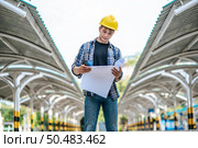 Architects hold the building plan and check the work. Стоковое фото, агентство Ingram Publishing / Фотобанк Лори