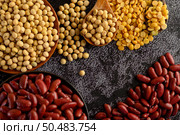 Legumes, and beans assortment on the black cement floor. Selective focus. Стоковое фото, агентство Ingram Publishing / Фотобанк Лори