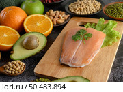 legumes, fruit, and Salmon fish pieces on a wooden chopping board. Стоковое фото, агентство Ingram Publishing / Фотобанк Лори