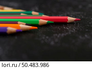 colorful crayon pencils with triangle shape on black background with copy space. Selective focus. Стоковое фото, агентство Ingram Publishing / Фотобанк Лори