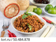 Spicy pork chops in a white dish consisting of lemons, chilies, and side dishes. Selective focus. Стоковое фото, агентство Ingram Publishing / Фотобанк Лори