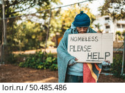 Beggars stand on the street with homeless messages please help. Стоковое фото, агентство Ingram Publishing / Фотобанк Лори