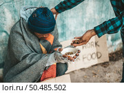 Beggars sitting under the overpass with a credit card and credit card swipe machine. Стоковое фото, агентство Ingram Publishing / Фотобанк Лори