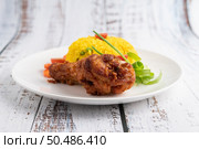 Chicken Biryani in a plate on a white wooden floor. Стоковое фото, агентство Ingram Publishing / Фотобанк Лори