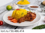 Chicken Biryani in a plate with spices on a white wooden floor. Стоковое фото, агентство Ingram Publishing / Фотобанк Лори