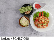 Thai papaya salad in a white plate with Yardlong beans, garlic, and Collard white. Top view. Стоковое фото, агентство Ingram Publishing / Фотобанк Лори