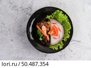 Appetizing Spicy Canned Sardine salad in spicy sauce in black ceramic bowl. Стоковое фото, агентство Ingram Publishing / Фотобанк Лори