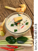 Tom Kha Kai in a bowl with kaffir lime leaves, lemongrass, red onion, galangal and chilli. Стоковое фото, агентство Ingram Publishing / Фотобанк Лори