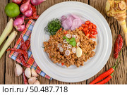 Spicy Minced Pork Salad on a white plate with red onion, lemon grass, garlic, yardlong beans, kaffir lime leaves, and spring onion. Стоковое фото, агентство Ingram Publishing / Фотобанк Лори