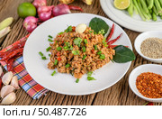 Spicy Minced Pork Salad on a white plate with red onion, lemon grass, garlic, yardlong beans, kaffir lime leaves, and spring onion. Стоковое фото, агентство Ingram Publishing / Фотобанк Лори