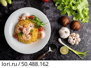 Shrimp fried rice with tomatoes Carrots and scallions on the plate. Стоковое фото, агентство Ingram Publishing / Фотобанк Лори