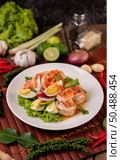 Shrimp Salad with Boiled Egg Lettuce and chopped scallions in a white plate. Стоковое фото, агентство Ingram Publishing / Фотобанк Лори