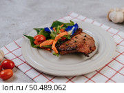 Pork Steak with Tomato, Carrot, Red Onion, Peppermint, Butterfly Pea Flower, and Lime. Стоковое фото, агентство Ingram Publishing / Фотобанк Лори
